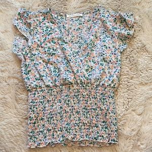 V-cut, multi-colored flower shirt.